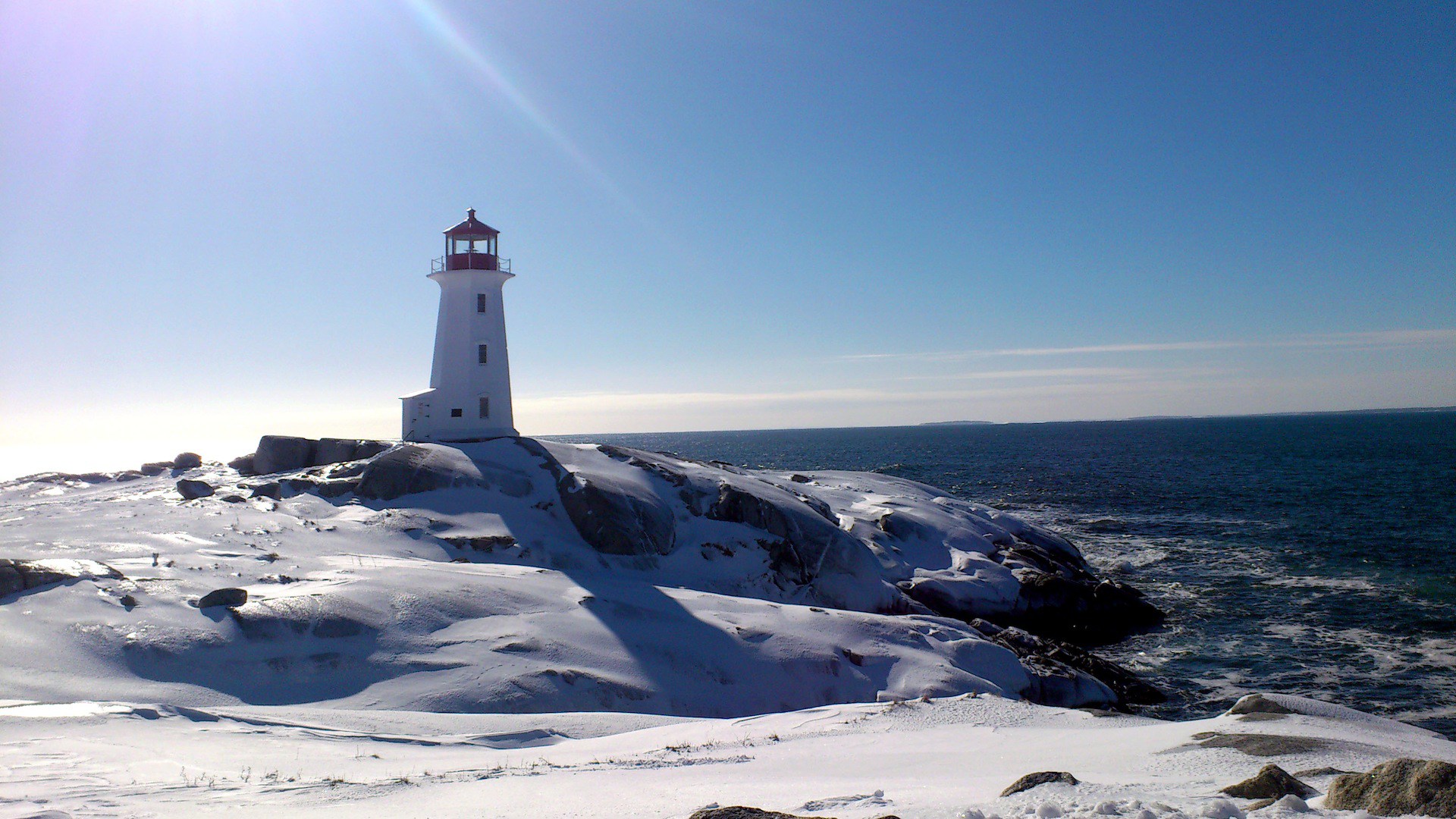 Winter time on the sea lighthouse in the sun