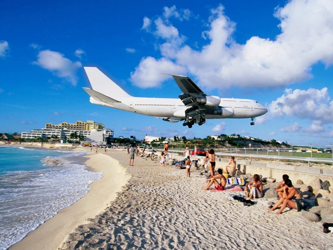 Download Wallpaper Airplane above the beach ready to land