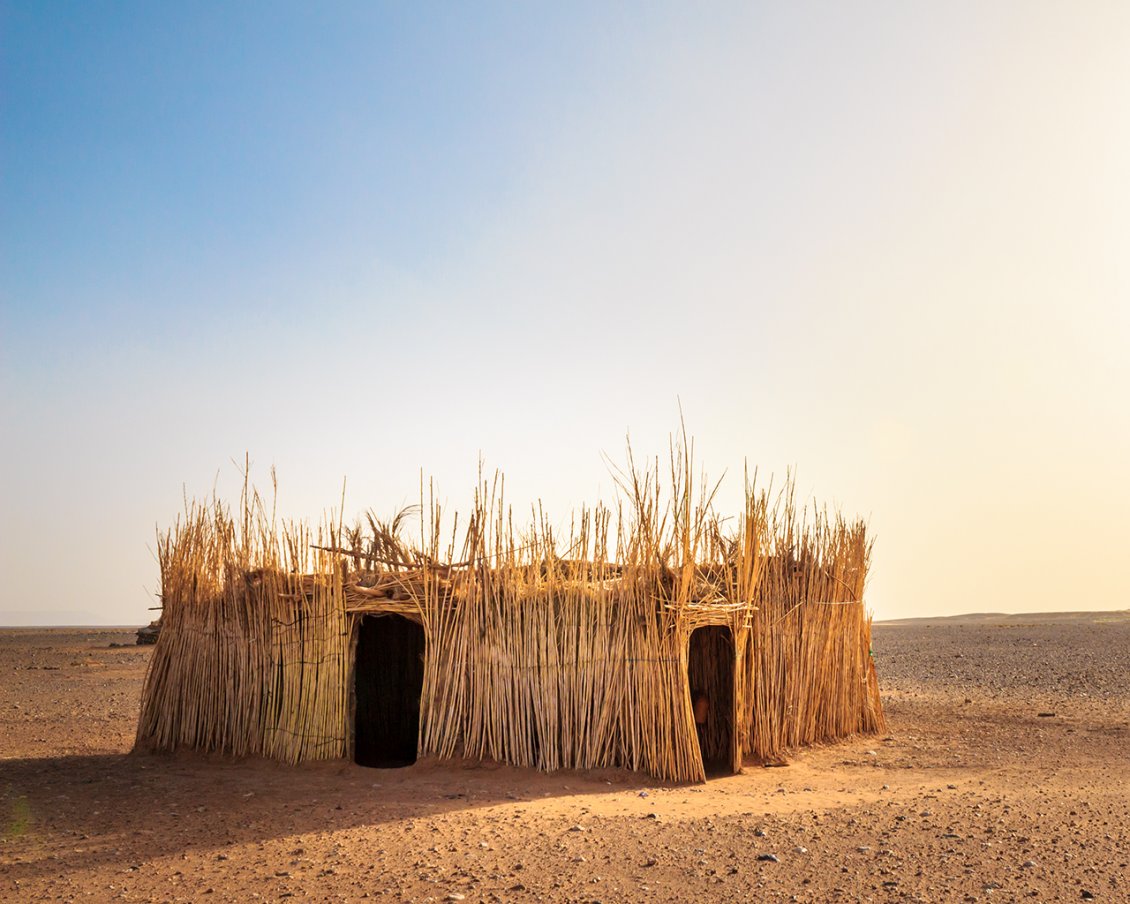 Download Wallpaper A house made of straw in the middle of desert