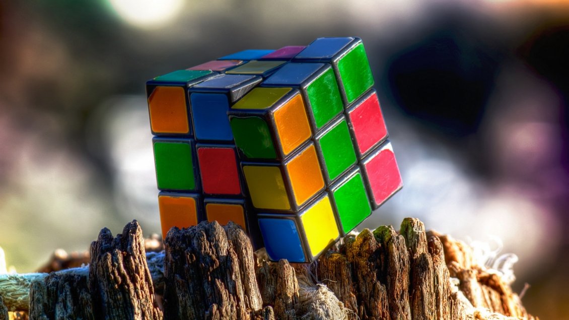 Download Wallpaper A colorful Rubik cube on the rocks