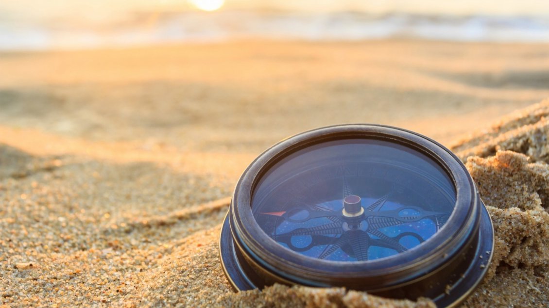 Download Wallpaper A compass in the sand on beach