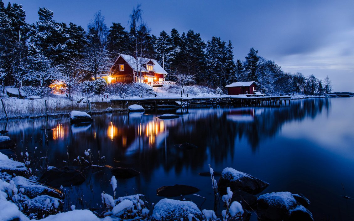 Download Wallpaper Winter holiday night at the cottage in the mountain
