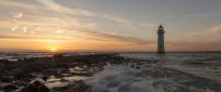 Beautiful Sea Sunrise And Lighthouse