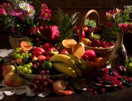 Table with many fruits and flowers