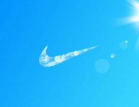 Nike logo by clouds on the blue sky