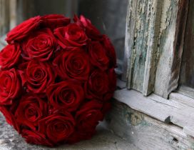 Wedding bouquet of red roses on windowsill