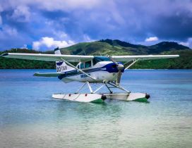 A white seaplanes was landed on water