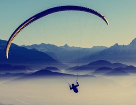 A man with paraglider over the mountains