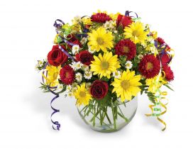 Bouquet of red, yellow and white flowers in the glass vase