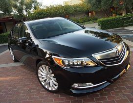 Black Acura RLX in front of house