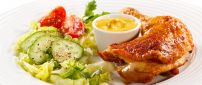 Chicken drumstick with sauce and salad