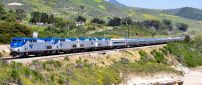 Gray and blue train on foothills