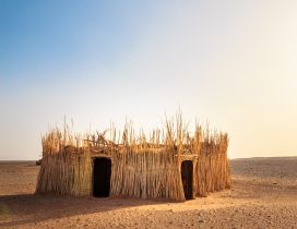 A house made of straw in the middle of desert
