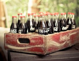 Old wooden box full with coca cola bottles