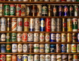 A wall of different brands of beer cans
