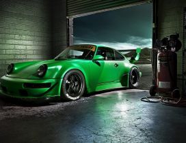 Green Porsche Carrera in a garage - Sports car