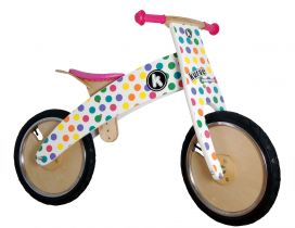 Kids balance bike with colorful dots and pink chair