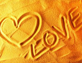 A heart and love letters in the sand