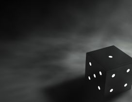 Black dice on a dark backgound