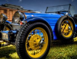 Blue and vintage Bugatti type 37 with yellow wheels
