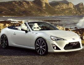 White Toyota FT-86 on the shore of sea