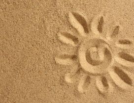 Drawing in the golden sand - happy sun