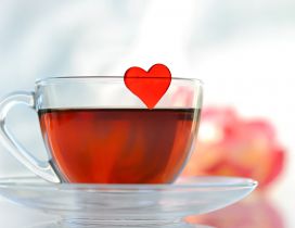 Red heart in a cup of sweet tea - Love mornings