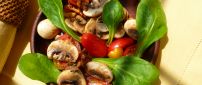 Delicious salad with mushrooms tomatoes and spinach
