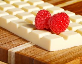 White chocolate bar and two delicious raspberry fruits