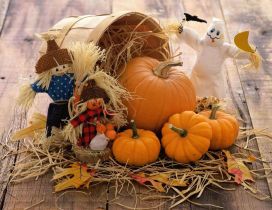 Funny scarecrow and Halloween pumpkins