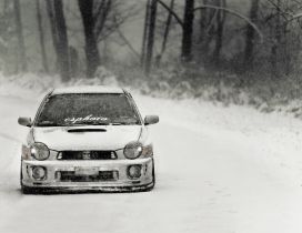 White race car on the road in the winter season