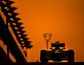 Formula 1 race car in the light of orange sunset