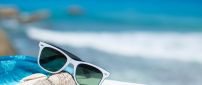 Sunglasses and shells -Wonderful blurry ocean on background