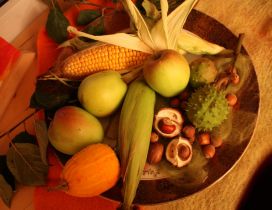 Autumn goodies in one plate - apples, nuts and corn