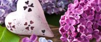 Painted Lilac flowers on a stone in shape of heart