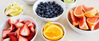 Delicious summer fruits in white cups - Vitamin color meal