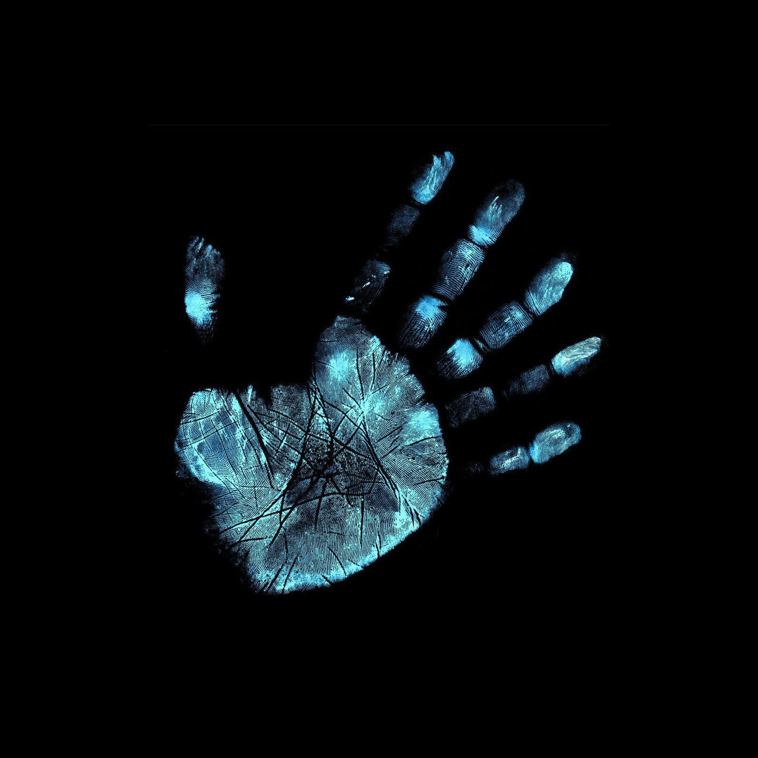 Blue footprint of hand on black background