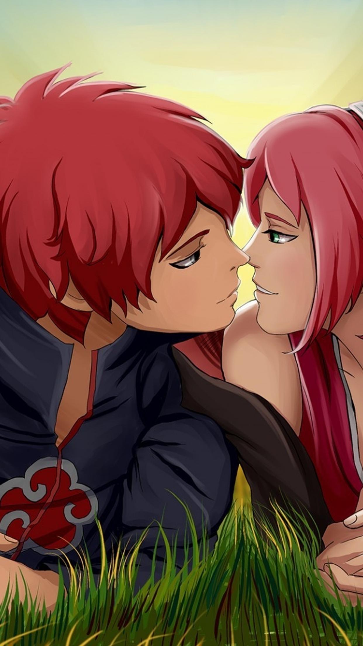 An anime couple with red hair kissing in the grass