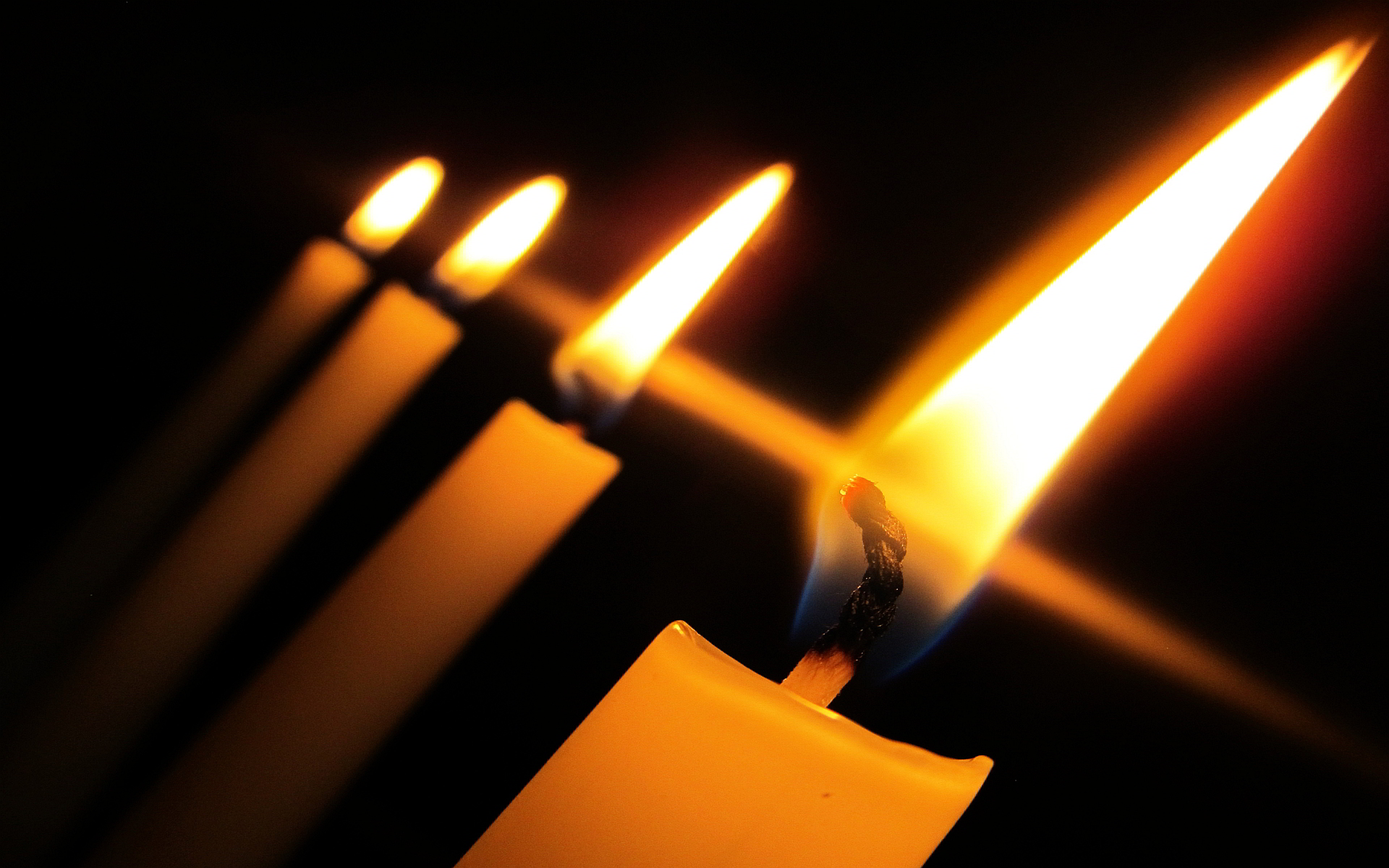 Lit candles - Dark with lights wallpaper