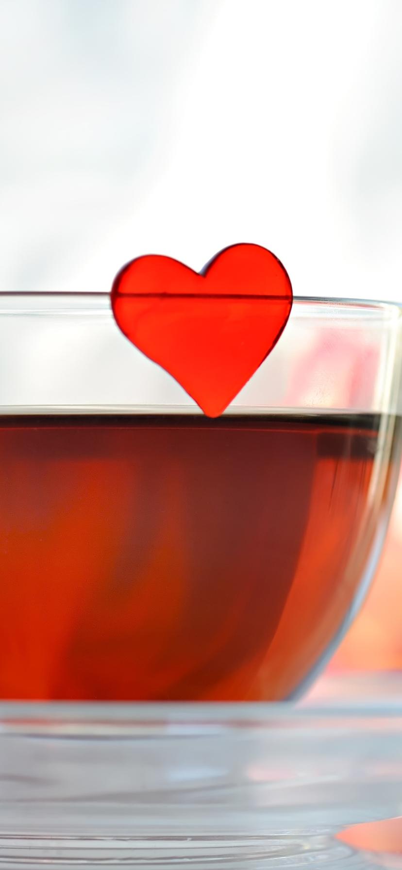Red heart in a cup of sweet tea - Love mornings