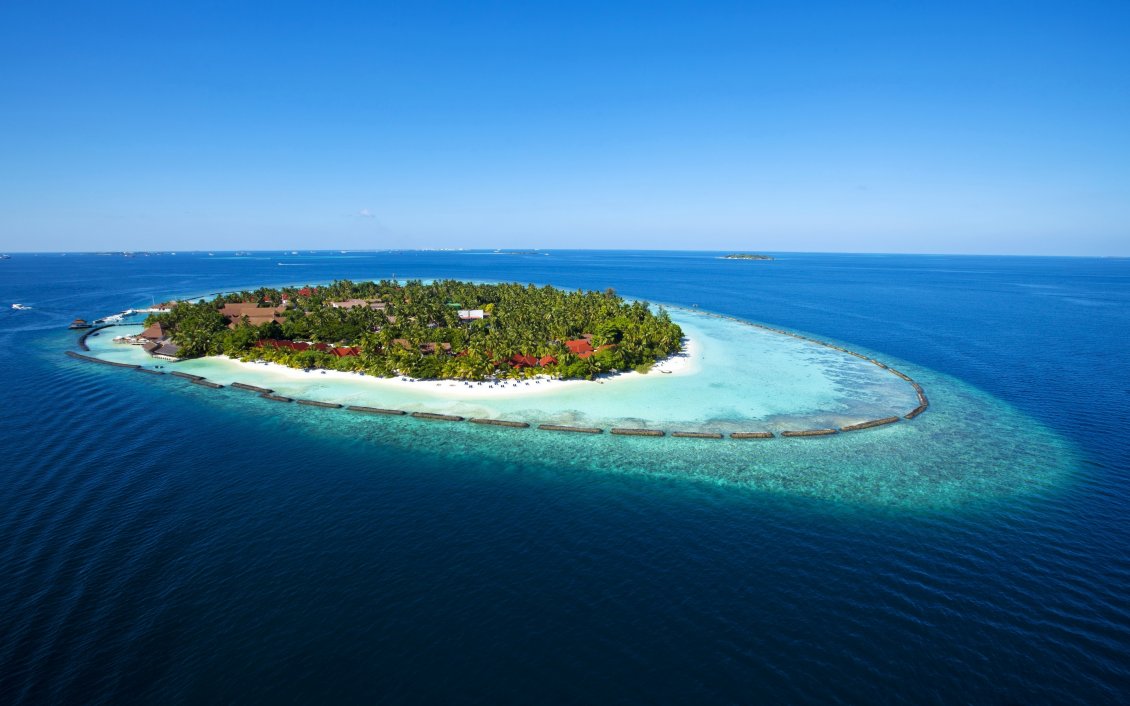 Download Wallpaper Island in the middle of the sea. Blue water and blue sky