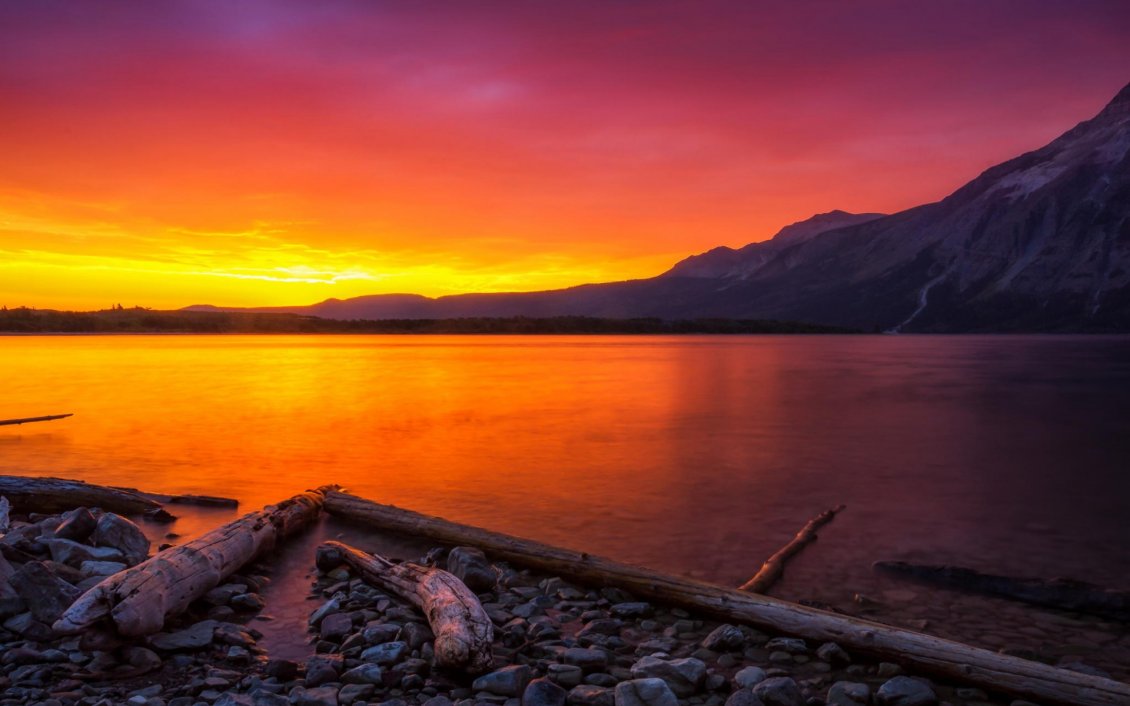Download Wallpaper Orange sunset over a mountain lake