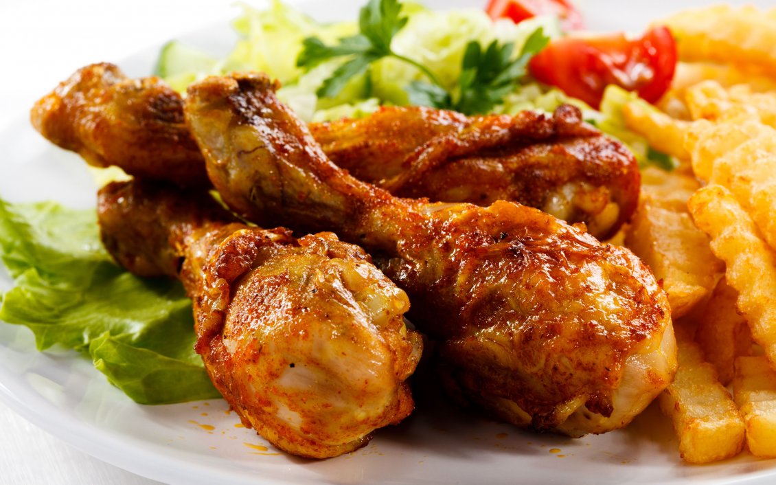Download Wallpaper Chicken drumsticks and fries with salad and tomato