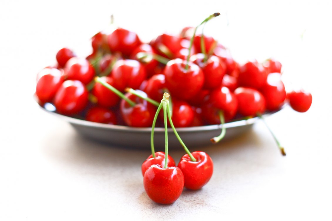 Download Wallpaper A bunch of three cherries and a plate full of cherries