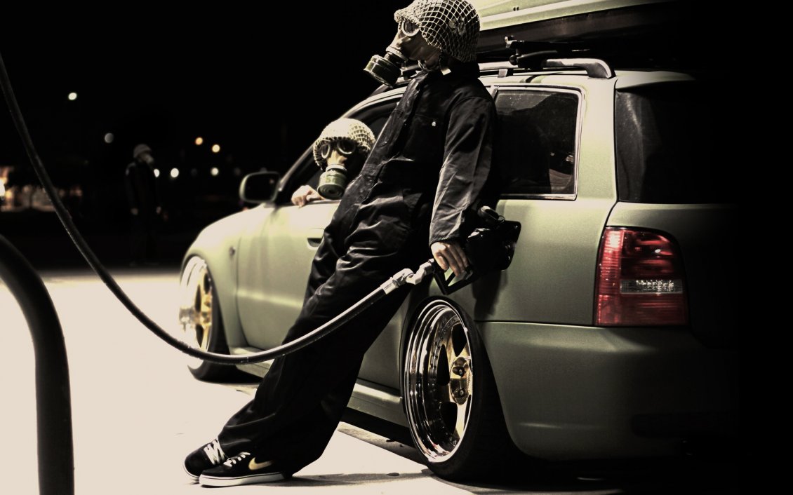 Download Wallpaper Man with gas mask getting gas at a gas station