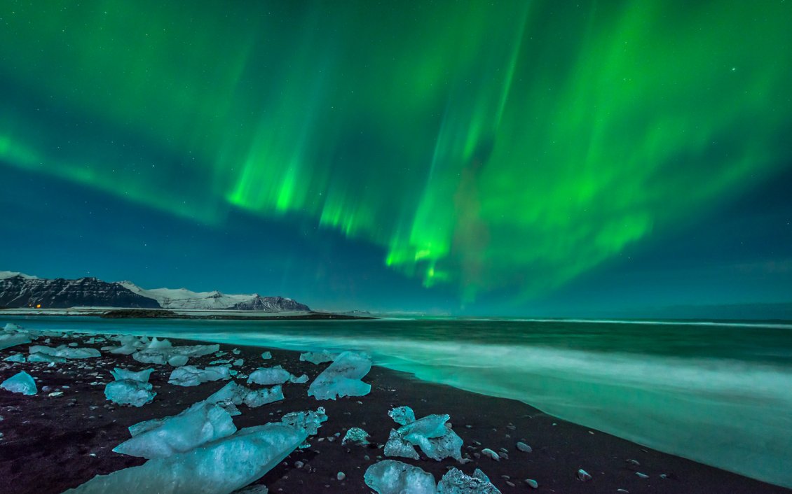 Download Wallpaper Green aurora borealis over the ocean