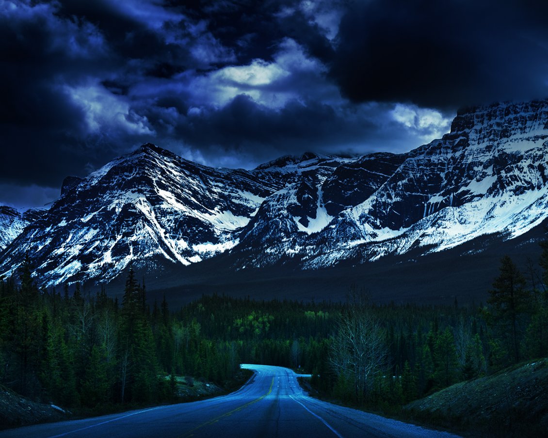 Download Wallpaper A road between the trees near the mountains