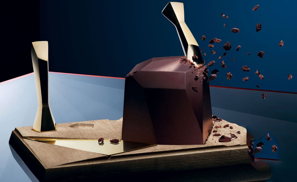 Download Wallpaper Chocolate shards falling from a big chocolate cube