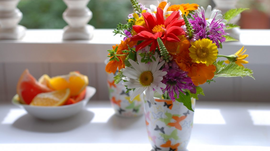 Download Wallpaper Many different colored flowers in a cup on the table