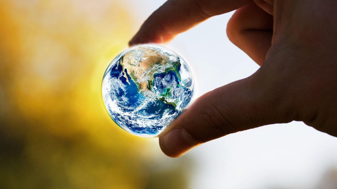Download Wallpaper A small earth globe - The world in our hands